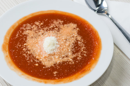 Tomato soup with shredded parmesan cheese on top