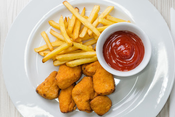 Chicken nuggets with french fries and ketchup