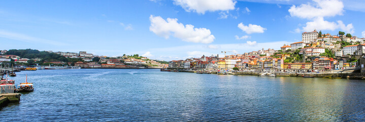 View of the historic city of Porto, Portugal with the Dom Luis bridge and blue sky /  Ancient city Porto,metallic Dom Luis bridge.