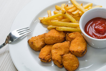 Chicken nuggets with french fries and ketchup