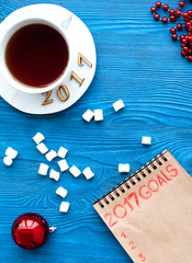 Plans for new year on wooden background top view