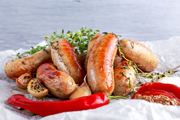 Home-made Pork Sausages on crumpled paper with thyme