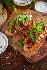 Grilled Steak Sandwich with mushrooms, goat's cheese butter and rucola leaves on top