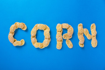 word of corn flakes on a blue background, lettering