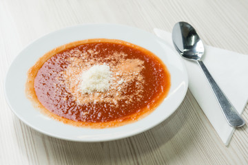 Tomato soup with shredded parmesan cheese on top