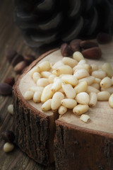 Peeled pine nuts on a wooden stand