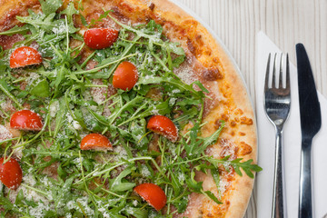 Detail of delicious salami pizza on the table