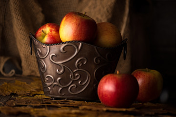 Apples in Decorative Bucket in Subdued Lighting