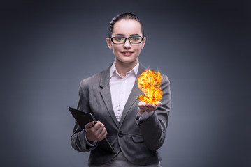 Businesswoman holding burning american dollar sign