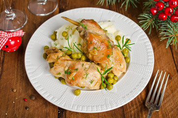 Oven Baked rabbit legs with potatoes and rosemary