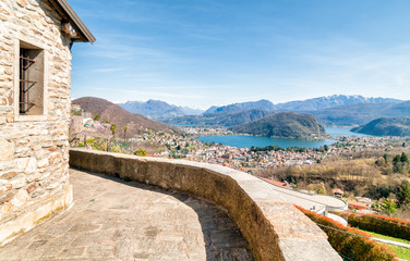 Fototapeta premium Panoramic view of Lake Lugano and the Swiss Alps from Cadegliano Viconago, Varese, Italy 