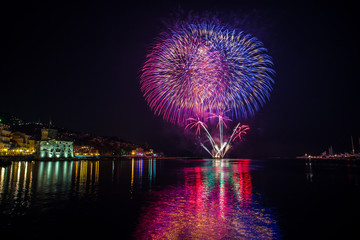 Colorful fireworks over the water on the beach