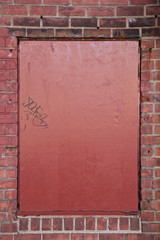 Red Metal Plate on Brick Wall