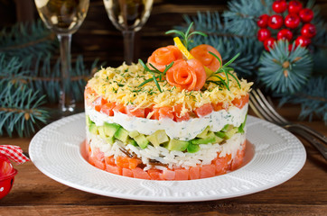 Layered salad with salmon, avocado and cream cheese