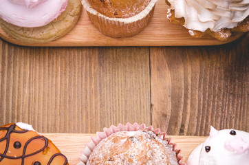 abundance of cakes with the place for the text/abundance of cakes on a plate on a wooden surface