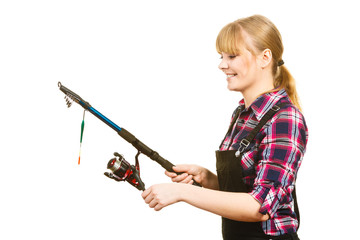 Similing woman wearing check shirt holding fishing rod