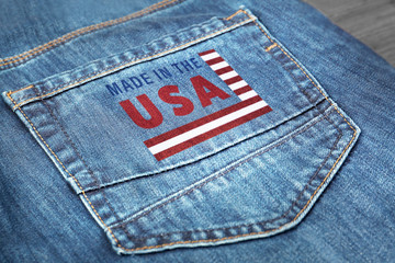Printed text MADE IN THE USA on jeans pocket, closeup. Manufacturing quality concept.