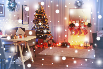 Beautiful Christmas fir tree at festive decorated living room. Snowy effect. Christmas celebration concept.