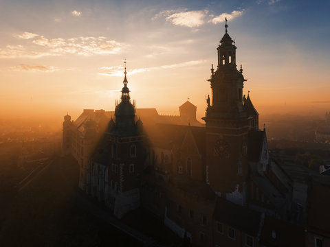 Wawel castle at sunrise in the mystic fog, orange light 