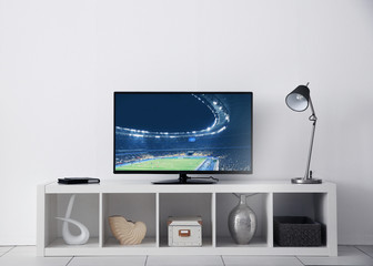 Watching football game on television at home. Leisure and entertainment concept.