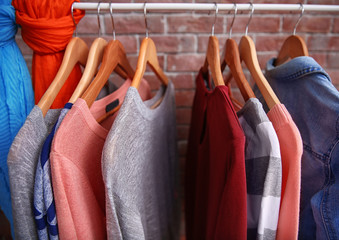 Hangers with different female clothes, closeup