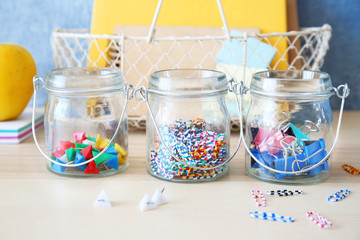 Paperclips and other tools in glass jars