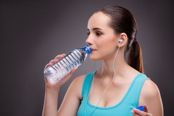 Woman doing sports with bottle of fresh water