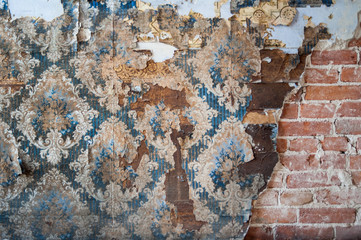 Vintage textures: old wallpaper, peeling paint, brick wall and layers of different colorful backgrounds.