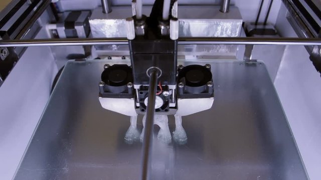 Three dimensional printer during work in laboratory, 3D plastic printer, 3D printing