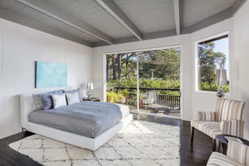 Amzing bright luxurious bedroom interior with balcony.