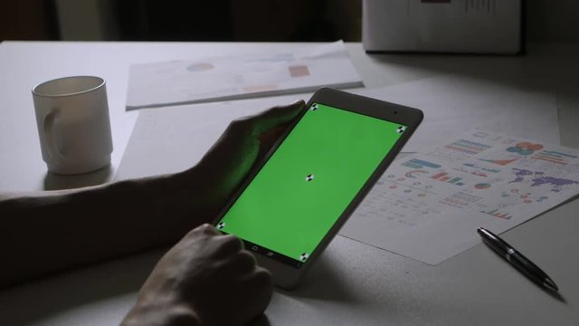 Man Using Tablet PC with Green Screen.