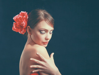 Young woman in red dress, isolated on black background