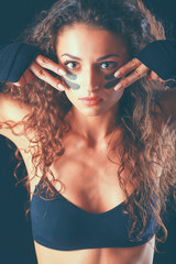 Portrait of young beautiful fitness woman, isolated on black background