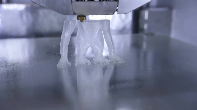Timelapse of 3D printer print the human like monkey using plastic filament