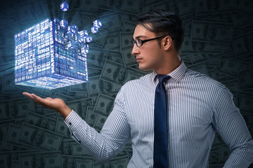 Businessman holding financial cube in business concept