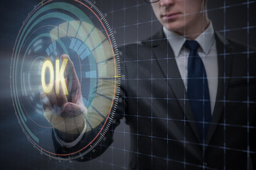 Businessman pressing virtual button OK