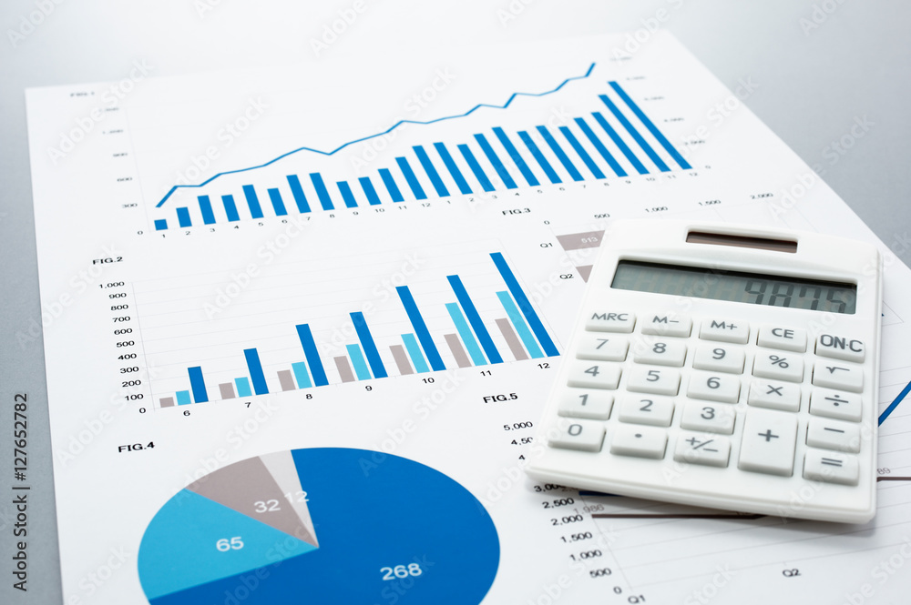 Poster Business document and calculator on gray reflection background.
Many graphs and charts. Concept image of data reviewing.
