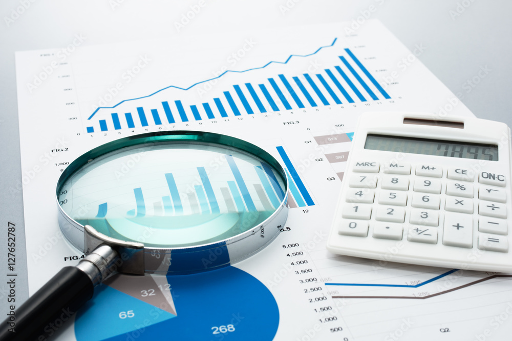 Poster Business document, magnifying glass, and calculator on gray reflection background.
Many graphs and charts. Concept image of data reviewing.
