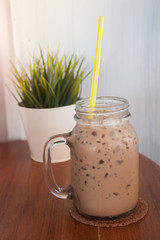 Iced coffee with green plant background
