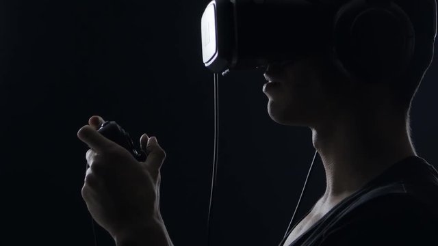 Virtual reality game. Close up of Man with pleasure uses head-mounted display