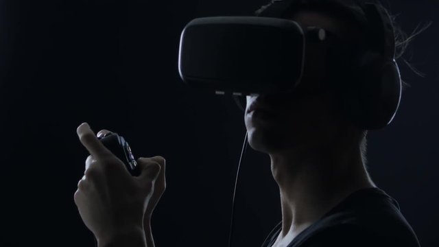 Virtual reality game. Close up of Man with pleasure uses head-mounted display