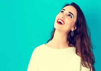 Happy young woman on a blue background