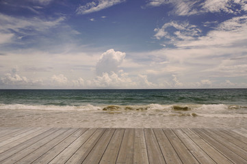 Fototapeta na wymiar Wooden Floor with sea beach blue sky sand sun daylight relaxation landscape 