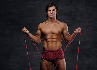 Fototapeta na wymiar A man doing biceps workouts with fitness trx straps.