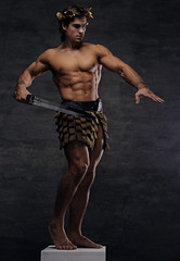 Fototapeta na wymiar Brutal ancient Rome athlete-warrior holds a sword.