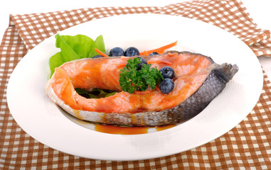 salmon steak with vegetables and fruit.