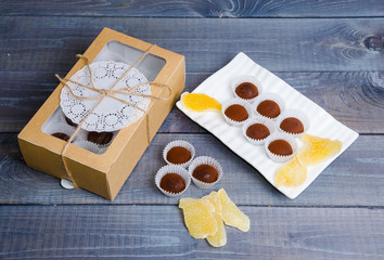 chocolate truffles with ginger candies in a gift box