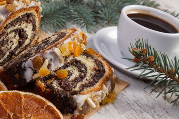 Poppy seeds cake, cup of coffee and spruce branches, dessert for Christmas