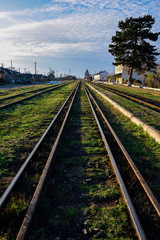Fototapeta na wymiar old iron rails with green grass