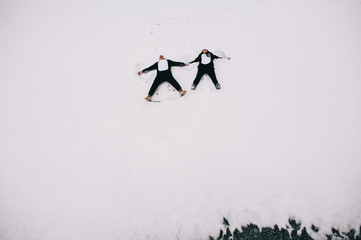 winter love story, a beautiful young couple in suits pandas